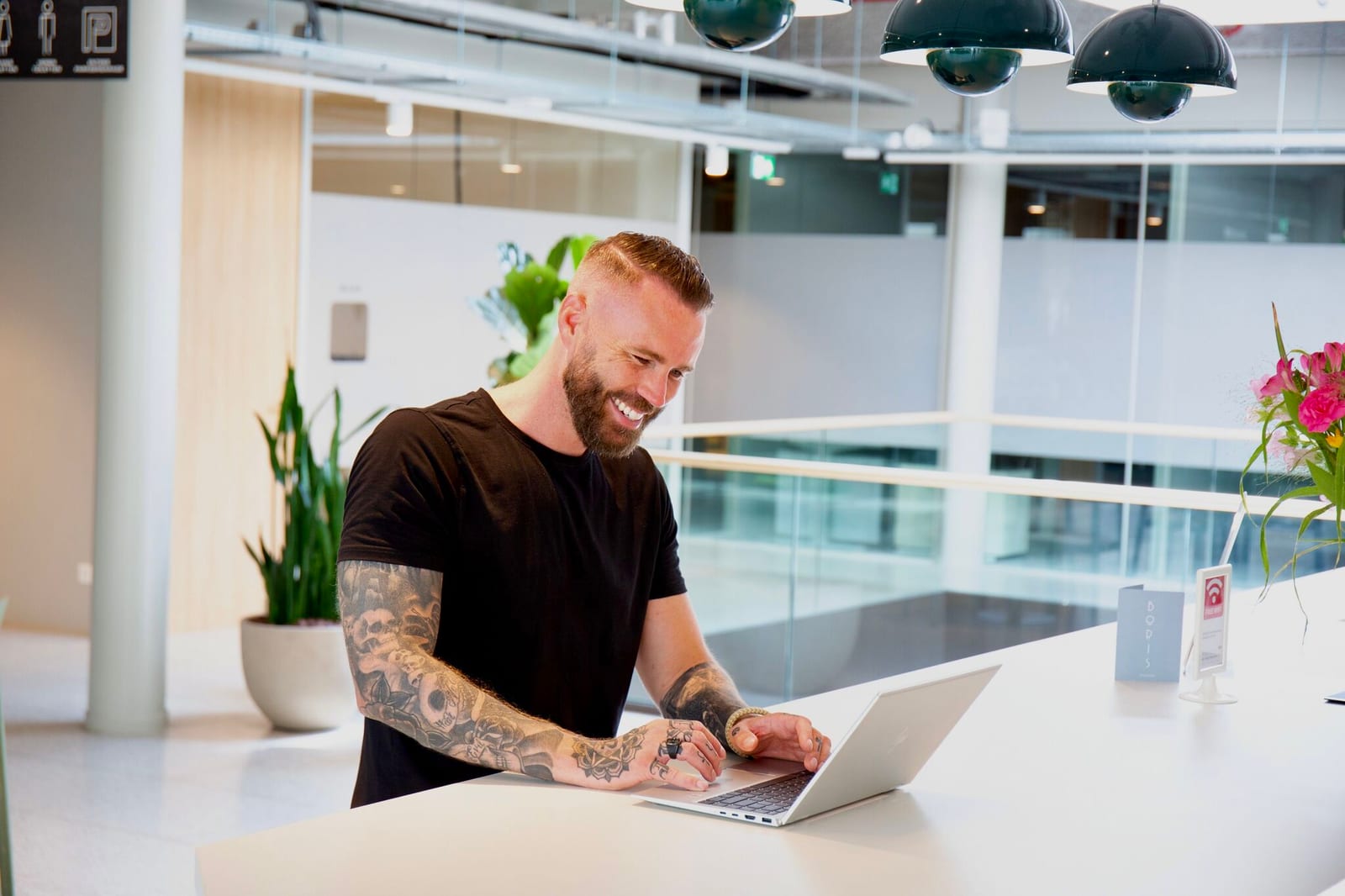 Jeroen Stolk working and smiling in a bright, modern space